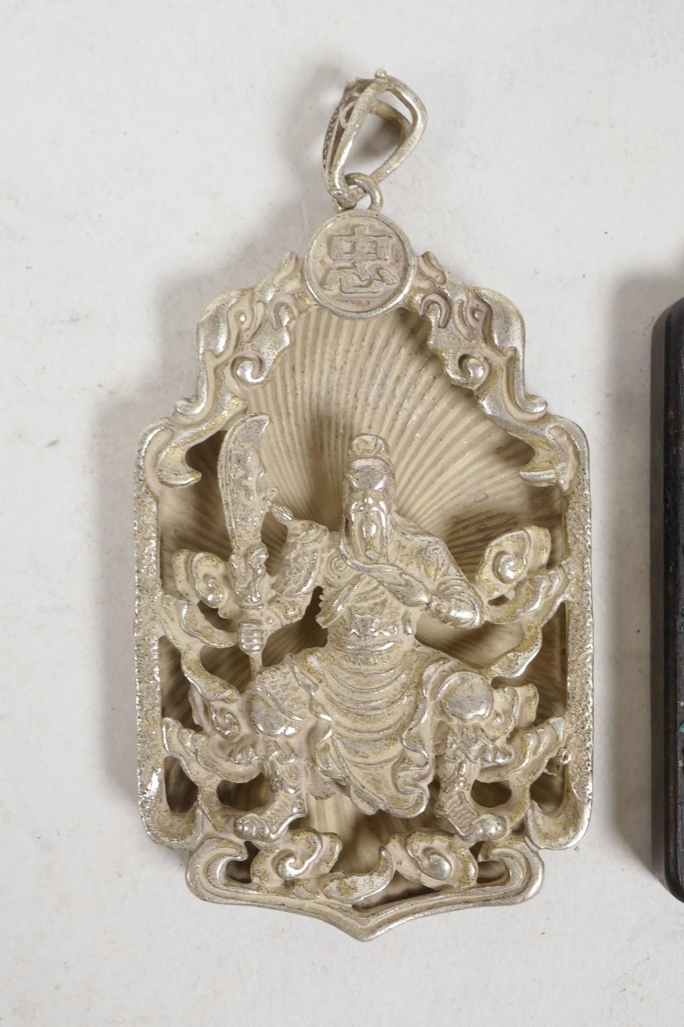 A Chinese white metal pendant decorated with a warrior, together with an Indian pendant decorated - Image 2 of 3