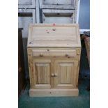 A pine fall front bureau, with fitted interior over a single drawer and cupboards, 28" x 17" x 43"