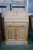A pine fall front bureau, with fitted interior over a single drawer and cupboards, 28" x 17" x 43"