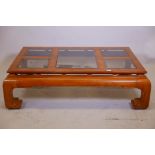 An Oriental style figured elm coffee table with five inset glass panels, 51" x 33" x 15"