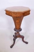A Victorian walnut pedestal trumpet workbox with fitted interior on octagonal and carved column