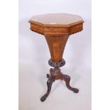 A Victorian walnut pedestal trumpet workbox with fitted interior on octagonal and carved column