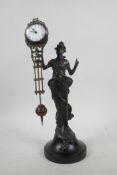 A bronzed spelter mystery clock in the form of an Art Nouveau woman, 11" high