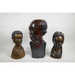 An African carved wood bust of a pipe smoking gentleman together with a pair of carved hardwood