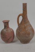 An antique unglazed red earthenware bottle vase with side handle, 9½" high, together with a