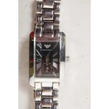 A lady's stainless steel cased dress wristwatch with black face and Roman numerals, on steel link