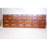 A C19th mahogany chemist's apothecary bank of drawers, each labelled, 77½" x 9½", 24" high