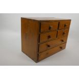 A small pine collector's chest of four short and two long drawers, 9½" high, 12½" wide, 7" deep