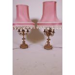 A pair of C19th French ormolu four branch candelabra, with inset porcelain panels, converted to