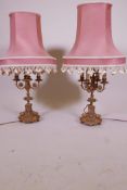 A pair of C19th French ormolu four branch candelabra, with inset porcelain panels, converted to