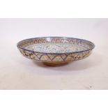 A glazed terracotta footed bowl with Islamic decoration, A/F, historic repairs to rim, 14"