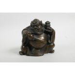 A Chinese filled bronze of a rotund Immortal, 4½" high