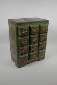 An Indian painted and distressed twelve drawer spice cabinet with brass banding, studs and