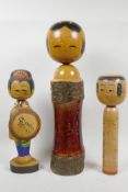 Three Japanese turned and painted wood Kokeshi dolls, largest 18" high