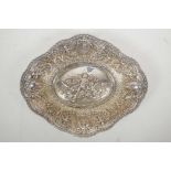 A silver plated shaped bowl with all over repousse decoration of cherubs, cornucopias, flowers and