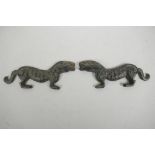 A pair of Chinese bronze scroll weights in the form of kylin with character inscriptions to side,