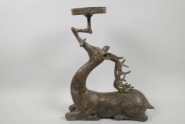 A Chinese bronze candle/bowl holder cast as a stage, 13" high