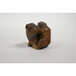 A late C19th/early C20th Japanese carved wood netsuke in the form of two Sharpei dogs, A/F, 1½" high