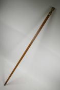 A C19th bone handled Malacca wood walking cane with brass and white metal cuffs, the handle with