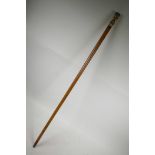 A C19th bone handled Malacca wood walking cane with brass and white metal cuffs, the handle with