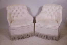 A pair of bedroom tub chairs with faux suede button back upholstery, raised on turned supports