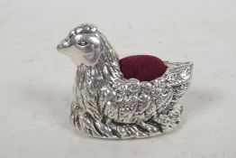 A small silver pincushion cast as a nesting hen, 1¾" long