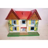 A mid C20th hand painted doll's house in plywood, with two opening doors at the front to reveal the