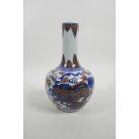 A Chinese blue and white porcelain bottle vase with fo dog decoration highlighted with red, 4 charac