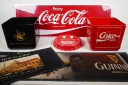 A selection of pub items featuring iconic logos; a perspex Coca-Cola sign, a Coca-Cola ice bucket, a