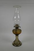 An ornate pressed glass oil lamp, 17" high