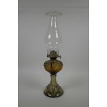 An ornate pressed glass oil lamp, 17" high
