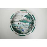 A Chinese famille verte porcelain dish with a rolled rim, decorated with figures in a rice paddy, Ka