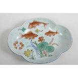 A Chinese petal shaped serving dish decorated with carp amongst water plants painted in bright ename