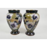 A pair of Doulton Lambeth bulbous vases with raised floral and tube lined decoration marked for Emil