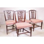 A set of four C18th mahogany Hepplewhite chairs, with carved and pierced reeded backs, decorated wit