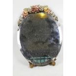 A small oval bevelled glass mirror with Barbola work floral decoration, 11" x 8"