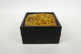 A Chinese hardwood box and cover inset with a hardstone panel, with carved figural decoration, 5½" x