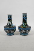 A pair of Chinese black ground cloisonne vases decorated with Asiatic flowers, 6½" high