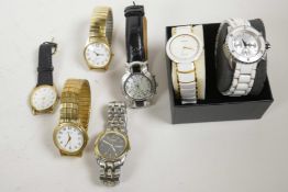 Two lady's watches with white linked straps, and another in a similar style with a leather strap and