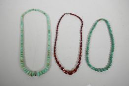 Two green hardstone graduated bead necklaces and another faceted and graduated bead necklace, 22" lo