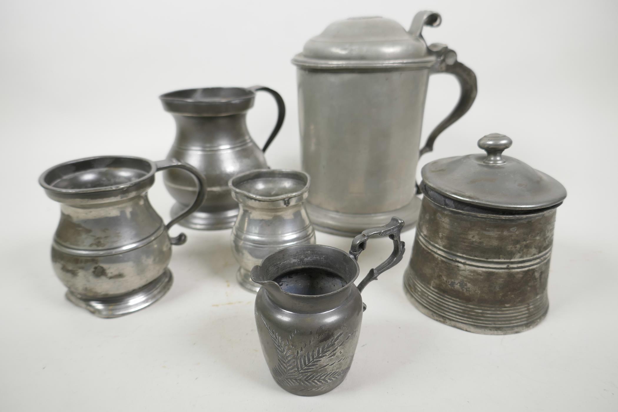 A collection of C18th pewter vessels including a large lidded tankard, English c.1780, with double d