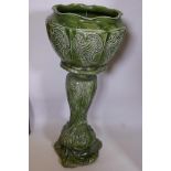 A green glazed pottery jardiniere pedestal of organic form with all over green glaze, 33" high