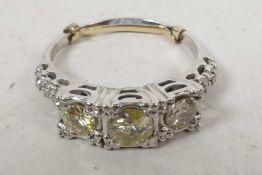 An Art Deco 18ct white gold set three stone diamond ring (total 1.3cts), size 'T' with clip to reduc