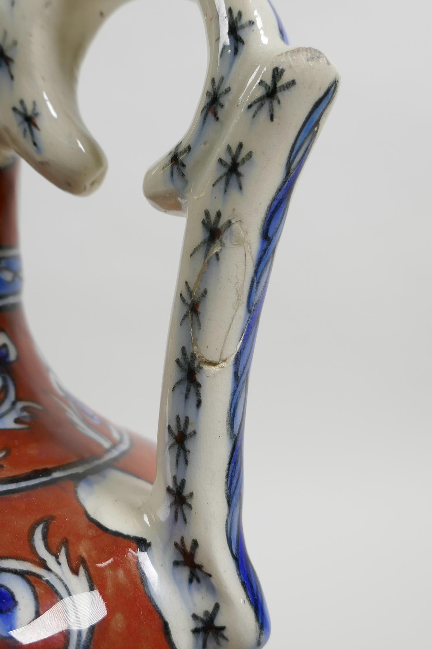 An early C20th Turkish Kutahya pottery ewer with traditional floral decoration, repair to handle, 10 - Image 5 of 7