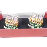 An unusual pair of silver and plique a jour cufflinks in the form of owls