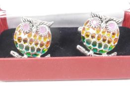 An unusual pair of silver and plique a jour cufflinks in the form of owls