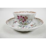 A Chinese export Yongzheng period famille rose tea bowl and saucer, delicately enamelled floral spra