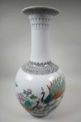 A Chinese famille rose porcelain floor vase, mid C20th, painted with a pair of peacocks, peony bloss