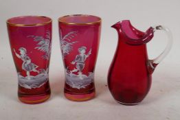 Two Mary Gregory style cranberry glass beakers, and a C19th cranberry glass jug, 5¼" high