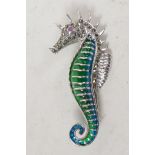 A silver and plique a jour brooch in the form of a seahorse with ruby eye, 2" long